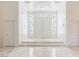 Elegant foyer with marble floors, high ceilings, and decorative glass above a double door at 56 Quail Run Rd, Henderson, NV 89014