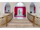 Foyer with marble stairs, arched doorways, and ornate gold railings at 56 Quail Run Rd, Henderson, NV 89014