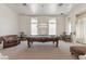 Spacious game room with a pool table, seating, and large windows with elegant drapes at 56 Quail Run Rd, Henderson, NV 89014