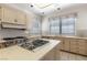 Kitchen with stainless steel appliances, gas cooktop, and light wood cabinetry at 56 Quail Run Rd, Henderson, NV 89014