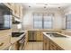 Spacious kitchen featuring stainless appliances, gas cooktop, and light wood cabinetry at 56 Quail Run Rd, Henderson, NV 89014
