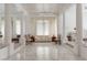 Bright living room featuring columns, neutral furniture, and elegant window treatments at 56 Quail Run Rd, Henderson, NV 89014