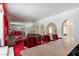 Large living room with mirrored wall, sofas, arches, and marble-topped bar at 56 Quail Run Rd, Henderson, NV 89014