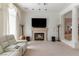 Spacious living room featuring a fireplace, columns, and large windows for natural light at 56 Quail Run Rd, Henderson, NV 89014