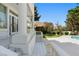 Elegant porch leads to a backyard oasis with a sparkling pool and meticulously landscaped garden at 56 Quail Run Rd, Henderson, NV 89014