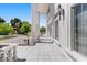 Expansive porch with white columns and tiled floor, offering a glimpse of the lush, green surroundings at 56 Quail Run Rd, Henderson, NV 89014