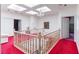Upstairs hallway with crystal chandelier and abundant natural light from skylights at 56 Quail Run Rd, Henderson, NV 89014