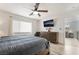 Modern bedroom featuring wood floors, a tv, and windows allowing plenty of natural light at 6141 May River St, Las Vegas, NV 89148