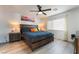 Cozy bedroom with a large bed, stylish furnishings, and a ceiling fan at 6141 May River St, Las Vegas, NV 89148