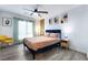 Bright bedroom features a ceiling fan, wood-look floors, and stylish decor for a modern and inviting space at 6141 May River St, Las Vegas, NV 89148