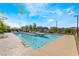 Upscale community pool with lounge chairs and covered grilling area at 6141 May River St, Las Vegas, NV 89148