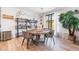 Contemporary dining area with a round table, modern chairs, decorative shelving, and a large window for natural light at 6141 May River St, Las Vegas, NV 89148
