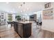 Open-concept kitchen and living area with stainless appliances, a dining area and natural light from the sliding glass door at 6141 May River St, Las Vegas, NV 89148
