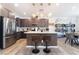 Modern kitchen featuring stainless steel appliances, a center island with seating, and stylish pendant lighting fixtures at 6141 May River St, Las Vegas, NV 89148