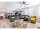Open-concept living area with a large sectional sofa, stylish accents, and bright natural light throughout the room at 6141 May River St, Las Vegas, NV 89148