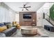 Bright living room features modern decor, comfortable seating, decorative wood accent wall, and an open layout at 6141 May River St, Las Vegas, NV 89148