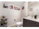 Contemporary powder room with a stylish vanity, modern fixtures, and decorative wall art at 6141 May River St, Las Vegas, NV 89148