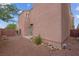 Backyard featuring gravel, small rock features and a concrete patio with view of fence at 6599 Netherseal Ave, Las Vegas, NV 89139