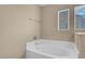 Bathroom featuring a soaking tub with a window for natural light at 6599 Netherseal Ave, Las Vegas, NV 89139