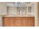 Bathroom features a double sink vanity with a large mirror and modern lighting at 6599 Netherseal Ave, Las Vegas, NV 89139