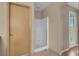 This bathroom features a stand up shower, tile flooring, and a door leading to the bedroom at 6599 Netherseal Ave, Las Vegas, NV 89139
