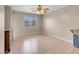 Cozy bedroom with neutral walls, wood floor, ceiling fan, and natural light at 6599 Netherseal Ave, Las Vegas, NV 89139