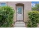 Close up of the front door with decorative glass and concrete steps leading up to it at 6599 Netherseal Ave, Las Vegas, NV 89139