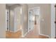 Hallway with light wood floors, neutral walls, and multiple doorways at 6599 Netherseal Ave, Las Vegas, NV 89139
