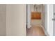 Hallway with view into a bathroom featuring a wooden vanity at 6599 Netherseal Ave, Las Vegas, NV 89139