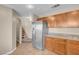 Eat-in kitchen with stainless steel refrigerator and modern wooden cabinets at 6599 Netherseal Ave, Las Vegas, NV 89139