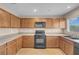 Functional kitchen with wooden cabinets, modern appliances, and ample counter space at 6599 Netherseal Ave, Las Vegas, NV 89139