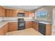 Bright eat-in kitchen featuring wooden cabinets, modern appliances, and ample counter space at 6599 Netherseal Ave, Las Vegas, NV 89139
