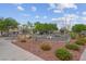 Fenced playground area with mature landscaping and stone groundcover at 6599 Netherseal Ave, Las Vegas, NV 89139