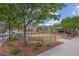Fenced playground area with swings and picnic tables with a gazebo at 6599 Netherseal Ave, Las Vegas, NV 89139
