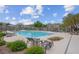 Community pool featuring lounge chairs, cabanas and lovely landscaping for relaxation at 6599 Netherseal Ave, Las Vegas, NV 89139