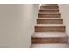 Carpeted stairway featuring neutral walls and staircase to the upper level at 6599 Netherseal Ave, Las Vegas, NV 89139