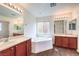 Bright bathroom with double sinks and a soaking tub at 6623 Hurkling Stone Ave, Las Vegas, NV 89139