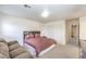 Bedroom with a queen bed, love seat, and closet at 6623 Hurkling Stone Ave, Las Vegas, NV 89139