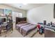 Comfortable bedroom with a work desk and neutral decor, perfect for relaxation and productivity at 6623 Hurkling Stone Ave, Las Vegas, NV 89139