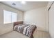 Bright bedroom with a large window and neutral tones, creating a relaxing atmosphere at 6623 Hurkling Stone Ave, Las Vegas, NV 89139