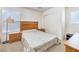 Cozy bedroom features light-colored carpet, a wooden bed frame, and matching nightstands at 6623 Hurkling Stone Ave, Las Vegas, NV 89139
