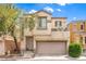 Charming two-story home featuring a balcony, attached garage, and well-maintained landscaping at 6623 Hurkling Stone Ave, Las Vegas, NV 89139