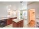 Bright eat-in kitchen boasts wood cabinets, white countertops, and an island at 6623 Hurkling Stone Ave, Las Vegas, NV 89139
