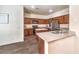 Spacious kitchen featuring stainless steel appliances, wood cabinets, and a functional center island at 6623 Hurkling Stone Ave, Las Vegas, NV 89139