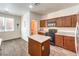 Updated kitchen with wood cabinets, black appliances, and a center island at 6623 Hurkling Stone Ave, Las Vegas, NV 89139