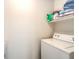 Efficient laundry area featuring a washer and shelving for organized storage of laundry supplies at 6623 Hurkling Stone Ave, Las Vegas, NV 89139