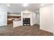 Open-concept living room with wood-style flooring seamlessly connected to the kitchen area at 6623 Hurkling Stone Ave, Las Vegas, NV 89139