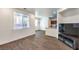 Inviting living room with ample natural light, wood-style floors, and easy access to the kitchen at 6623 Hurkling Stone Ave, Las Vegas, NV 89139