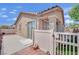 Cozy backyard featuring a patio, white picket fence, and a sliding glass door for indoor-outdoor living at 6705 Frances Celia Ave, Las Vegas, NV 89122
