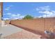 Backyard featuring a brick fence, rock landscaping, and a concrete patio at 6705 Frances Celia Ave, Las Vegas, NV 89122
